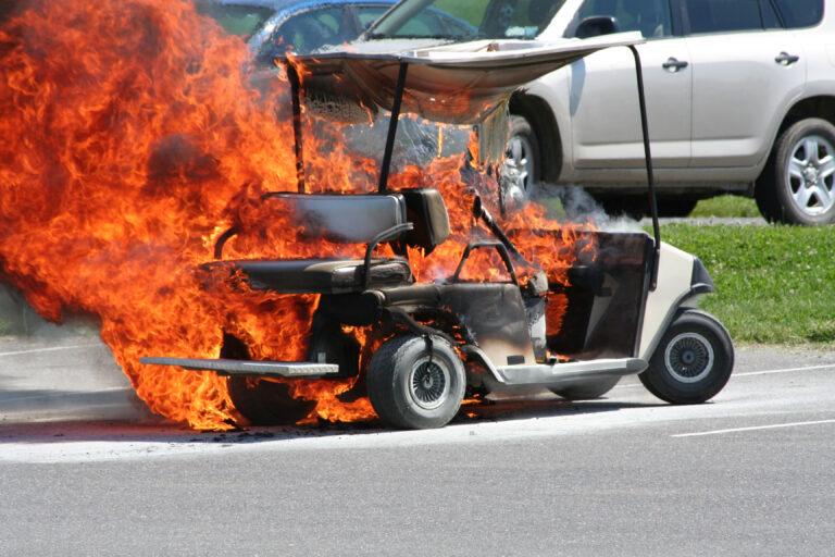 Transport cart electrical fire in parking lot.