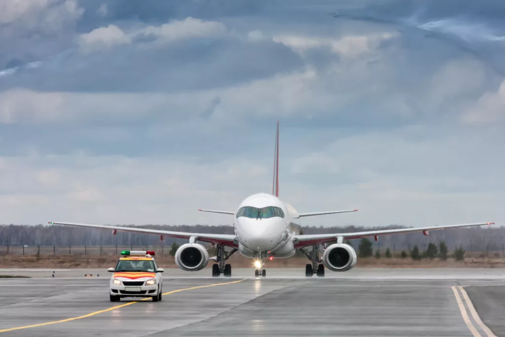A laptop battery fire on a United Airlines flight forced an emergency return to San Diego, sending four people to hospital.